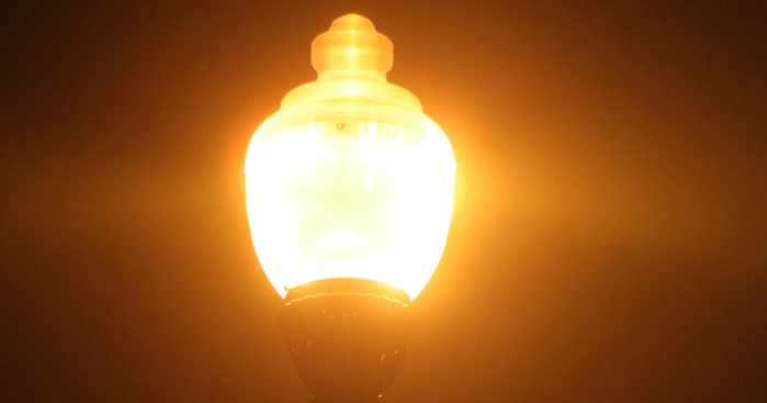 An "acorn" outdoor street light at night gives off a lot of glare because it's not shielded.